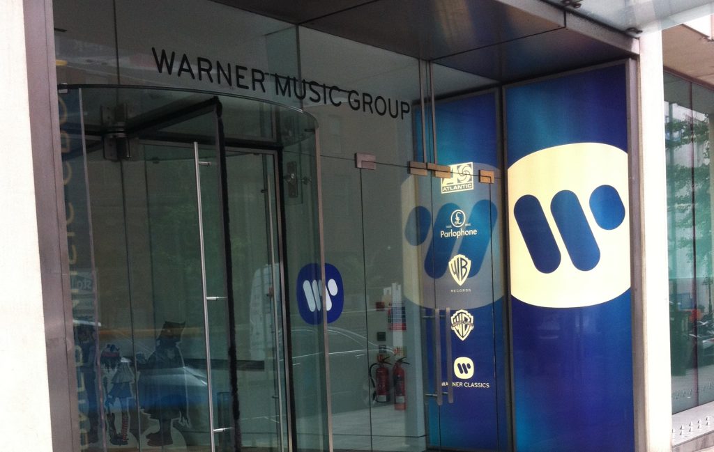 Entrance to Warner Music Group’s UK office with glass doors displaying Atlantic, Parlophone, Warner Records, and Warner Classics logos.
